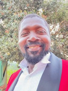 Portrait of a GEHA Advisory Board Member smiling outdoors, symbolizing community-focused service and leadership.